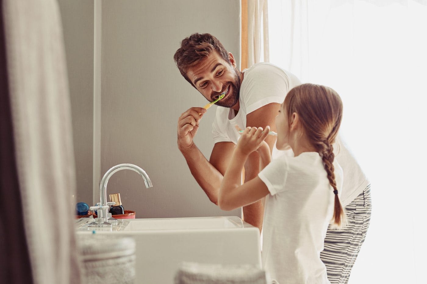 Dad Daughter Brushing Teeth I Stock 684029036