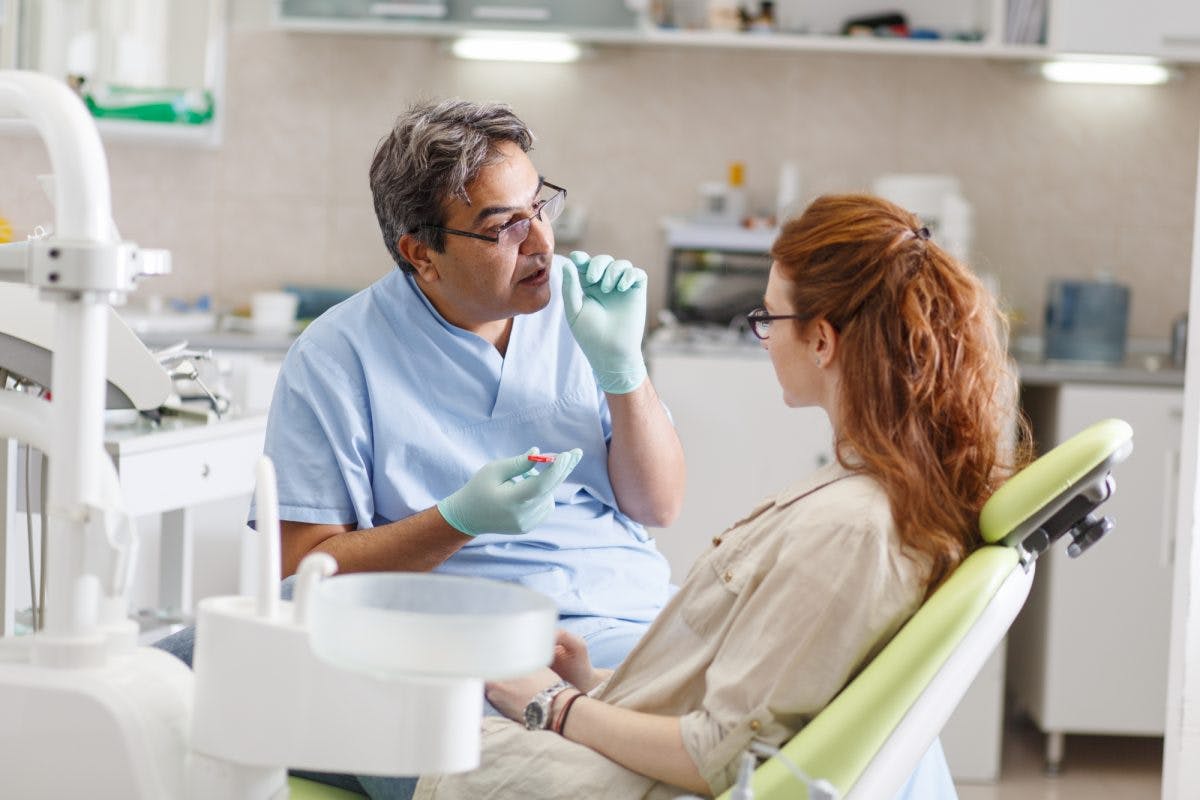 50S Male Dentist And 20S Patient Shutterstock 512653249