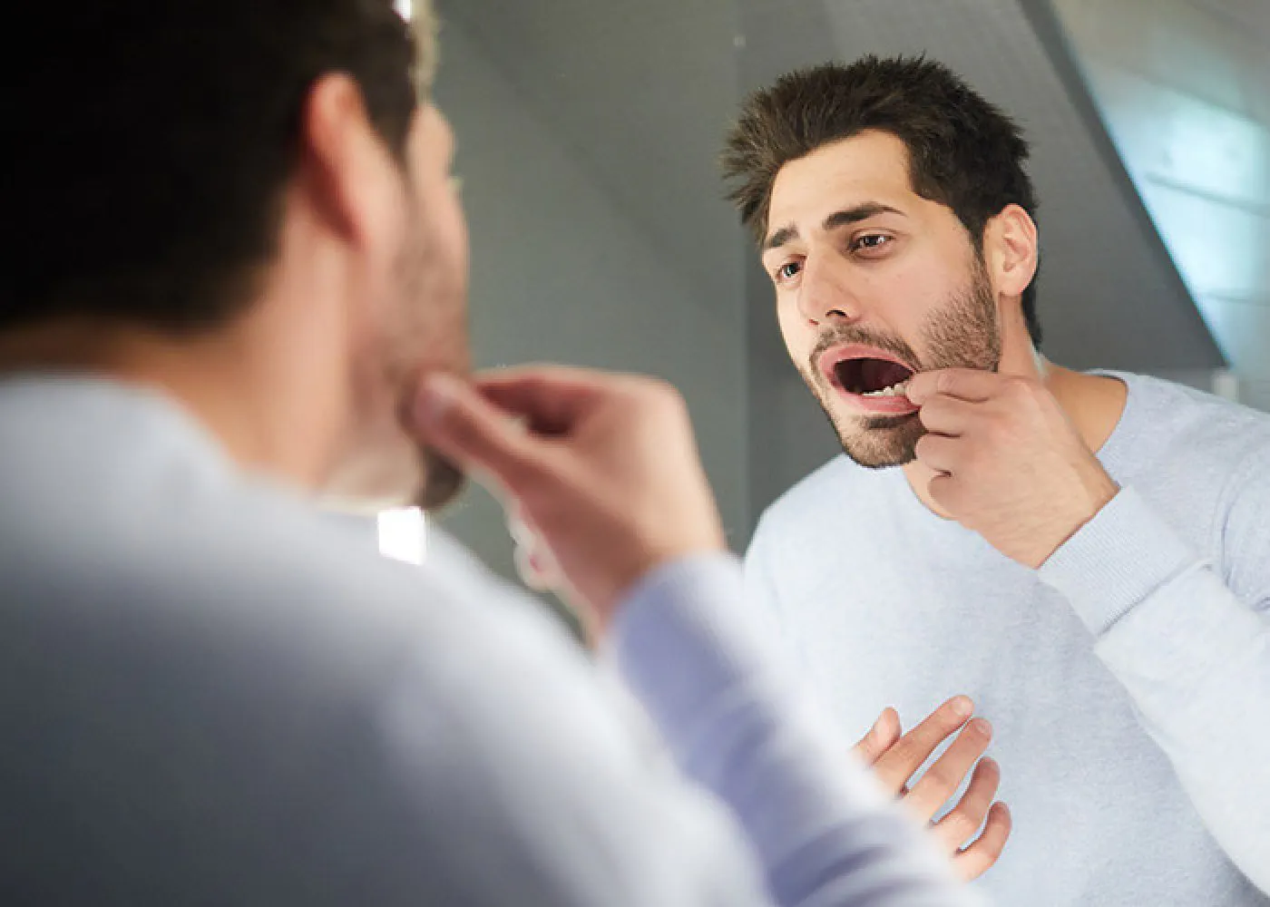 Man Checking Teeth In Mirror Portman Dental Care